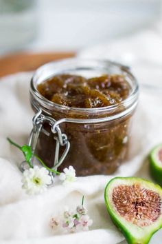 fig jam in a glass jar with the title how to make fig jam on it