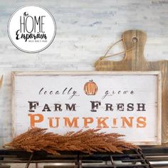 a sign that says farm fresh pumpkins on the top of an oven with some dry grass in front of it