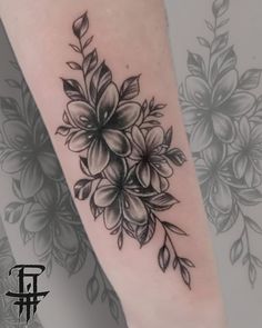 a black and white flower tattoo on the leg