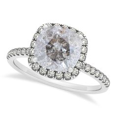 a white diamond ring with diamonds on the band and an oval cut stone in the center