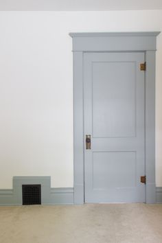 an empty room with a white door and carpet