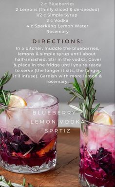 two glasses filled with purple lemonade and rosemary spritz on top of a wooden table