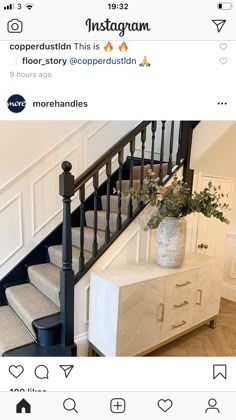 a white dresser sitting next to a stair case