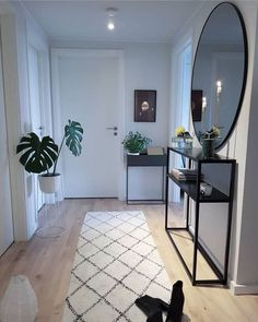 a living room filled with furniture and a large mirror