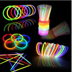 neon glow bracelets and rings on a black background