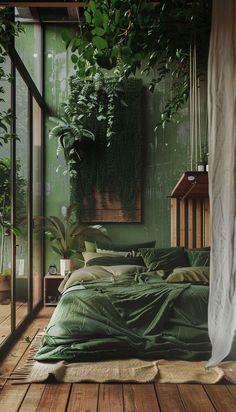 a bed with green sheets and pillows in a room that has plants on the wall