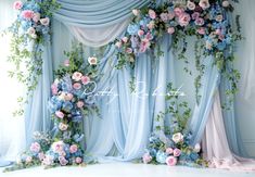 the backdrop is decorated with blue and pink flowers