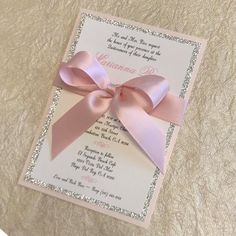 a wedding card with a pink bow on it