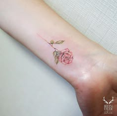 a small rose tattoo on the wrist