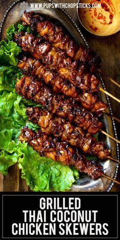 grilled thai chicken skewers with lettuce and sauce on the side