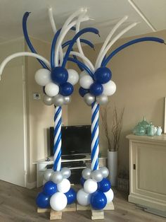 blue and white balloon arch in living room