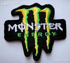 a patch with the word monster energy written on it and a large yellow, green and black logo