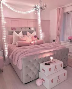 a bedroom decorated in pink and white with lots of lights