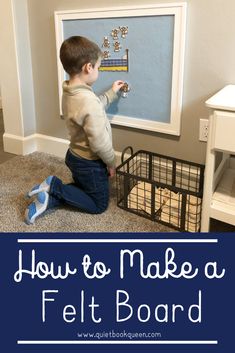 a toddler playing with a felt board in front of a white wall and blue carpet