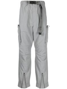 blue-grey water-repellent pleat detailing mid-rise elasticated waistband belted waist buckle fastening two side zip-fastening pockets two side cargo pockets two rear flap pockets tapered leg ankle zips Functional Nylon Pants With Belt Loops, Techwear Nylon Pants With Belt Loops, Nylon Techwear Cargo Pants With Belt Loops, Functional Nylon Cargo Pants With Belt Loops, Utility Nylon Parachute Pants With Belt Loops, Tapered Pants, Cargo Trousers, Tapered Legs, Flap Pocket