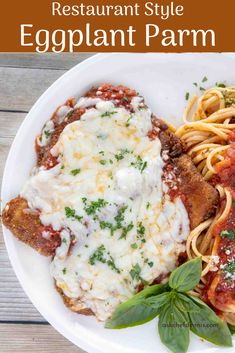 an eggplant parmesan is served on a plate with pasta and sauce