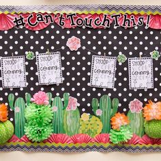 a bulletin board decorated with cactus and flowers