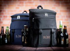 two cooler bags with beer bottles next to them