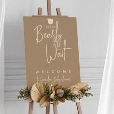 an easel holding a sign that says, we can't really wait welcome