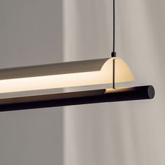 a modern light fixture hanging from the ceiling