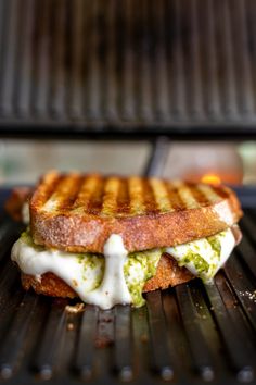 grilled cheese and pesto sandwich on the grill