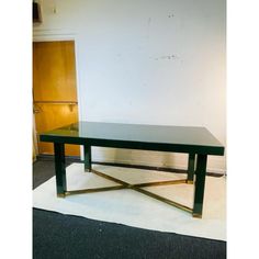 a glass table sitting on top of a carpeted floor next to a white wall