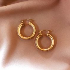 Classic Small Hoop Earrings In 14k Gold Filled, Chic Everyday Hoop Huggie Earrings, Trendy 14k Gold Everyday Earrings, Chic Yellow Gold Huggie Earrings, Chic Hoop Huggie Earrings For Pierced Ears, Trendy 14k Gold Filled Earrings For Everyday Wear, Everyday Tarnish-resistant Round Hoop Earrings, Chic Small Hoop Jewelry For Everyday, Chic Everyday Huggie Hoop Earrings