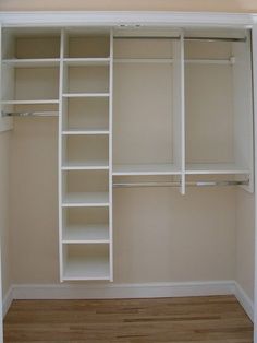 an empty closet with white shelves and wooden floors