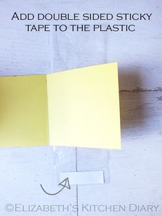 an open yellow sticky note sitting on top of a table