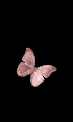 a pink butterfly flying through the air