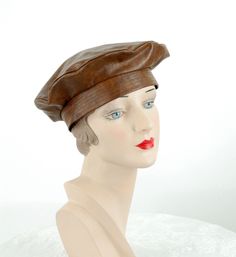 "Fantastic 1960s brown vinyl tam hat - faux leather - water proof. Self lined. No maker's labels. Good condition. There are some white marks on the top - shown. It measures 22\" in circumference. * Proud member of the Vintage Fashion Guild * For more vintage fashions, visit Vintage Runways' shop at http://www.vintagerunway.etsy.com. Follow on Instagram - instagram.com/vtgrunway" Vintage Distressed Brown Leather Hat, Vintage Distressed Brown Brimmed Hat, Distressed Brown Brimmed Vintage Hat, Vintage Brown Leather Hat, Retro Brown Adjustable Hat, Retro Brown Leather Hat, Vintage Brown Flat Cap, Retro Leather Cap, Retro Brown Hat