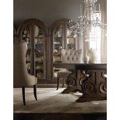 an elegant dining room with chandelier, chairs and china cabinet in the background