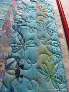 a close up of a quilted table runner