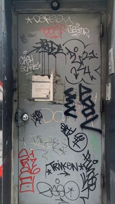 a door with lots of graffiti on it