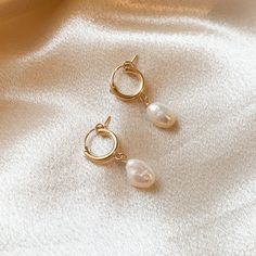 Hypoallergenic - Handcrafted - Waterproof - Tarnish Resistant White freshwater pearl earrings made with 14k gold hoops measuring 12mm across and 2mm in width, with high lustre white pearl accents. Gold filled jewelry is waterproof, hypoallergenic and made to last. Hypoallergenic Pearl Teardrop Hoop Earrings, Classic Gold Pearl Huggie Earrings, Hypoallergenic Teardrop Pearl Hoop Earrings, Delicate Huggie Pearl Earrings, Round Huggie Earrings With Pearl Charm As Gift, Classic Huggie Earrings With Pearl Charm As Gift, White Pearl Huggie Earrings With Pearl Charm, Gold Pearl Drop Huggie Earrings, Hypoallergenic Pearl Huggie Earrings