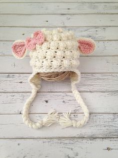 a crocheted cow hat with ears and tail