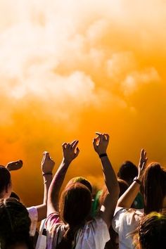 a group of people raising their hands in the air