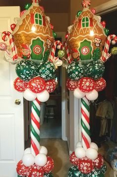 two large christmas decorations in the shape of candy canes and gingerbread houses on top of each other