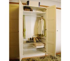 an open closet with clothes hanging on the door and shoes in the bottom shelf next to it