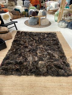 an area rug with many different colors and sizes on it in a store filled with furniture