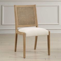 a wooden chair with white upholstered fabric on the seat and backrests