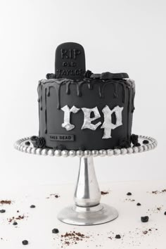 a black and white cake with the word rip on it