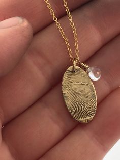 "A beautiful, forever keepsake.   This listing is for one pure Bronze fingerprint charm necklace taken from an ink or pencil fingerprint/thumbprint. Your charm is lovingly hand cut into either a puffy heart shape, circle, oval, or Long heart shape and assembled with a genuine birthstone of your choice. The necklace, (chain and all parts) are all 14k gold filled.  14K GOLD FILLED QUALITY: (VS GOLD PLATING)         **The exterior of our chain is 14kt gold and everything you can see or touch is a s Black Gold Jewelry, Fingerprint Jewelry, Gold Filled Necklace, Bronze Necklace, Family Necklace, Dope Jewelry, Jewelry Lookbook, Diy Schmuck, Girly Jewelry