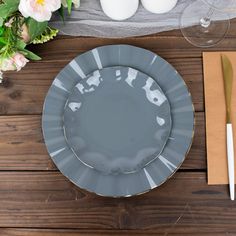 an empty plate and utensils on a wooden table