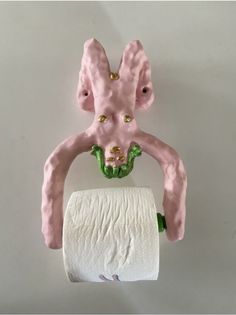 a pink bunny holding a roll of toilet paper