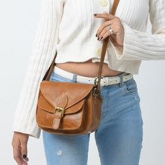 Trustpilot This Molina Brown Leather Satchel Cross-body is a perfect complement to highlight your everyday look. Carry it to your workplace or simply complete your brunch look with this lavish leather purse. Classy Leather Bags offers excellent craftsmanship to ensure uniqueness and exclusivity. The vintage-looking, semi-glossy surface of the satchel bag is water and scratch-resistant. It is underlined by a high-quality canvas, thus giving it a neat internal finish. It is diagonally put across t Leather Satchel Saddle Bag, Leather Lined Saddle Satchel Bag, Classic Everyday Saddle Bag, Leather Flap Bag With Detachable Strap, Versatile Shoulder Bag As Gift, Versatile Leather Shoulder Bag For Everyday, Everyday Use Saddle Satchel, Elegant Leather Shoulder Bag For Everyday, Elegant Everyday Leather Shoulder Bag