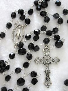 "This black Czech crystal rosary is made with 6mm beads. It is standard sized, measuring 27\" around with a 5\" crucifix drop. The rosary parts are pewter and the wires are hand turned and silver plated. It is a suitable unisex Catholic gift. The rosary will be slipped into a velvet bag and shipped in a bubble mailer." Silver Rosary With Black Beads And Crucifix, Black Cross Rosary As Gift, Black Crucifix Rosary Bracelet As Gift, Black Crucifix Rosary As Gift, Crystal Rosary, Catholic Rosary, The Rosary, Rosary Catholic, Catholic Gifts