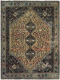 an antique rug with many different colors and patterns on it, including black, yellow, green