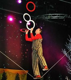 a man juggling on a circus ring