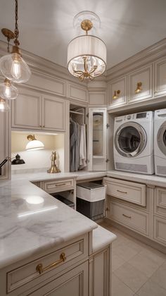 Find inspiration for designing a combined mudroom and laundry room with these creative layout ideas that optimize both function and aesthetics. Laundry Room Two Washers And Dryers, Tv In Laundry Room, Boujee Laundry Room, Mansion Laundry Room, Dream Laundry Room Luxury, Large Laundry Room Design, Glam Laundry Room, French Laundry Room, Laundry Room Accent Wall